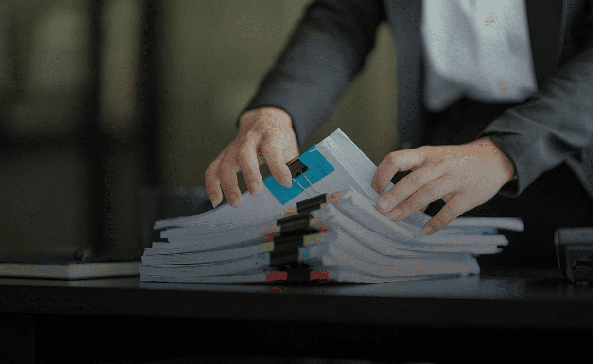 Businessperson handling paperwork in office