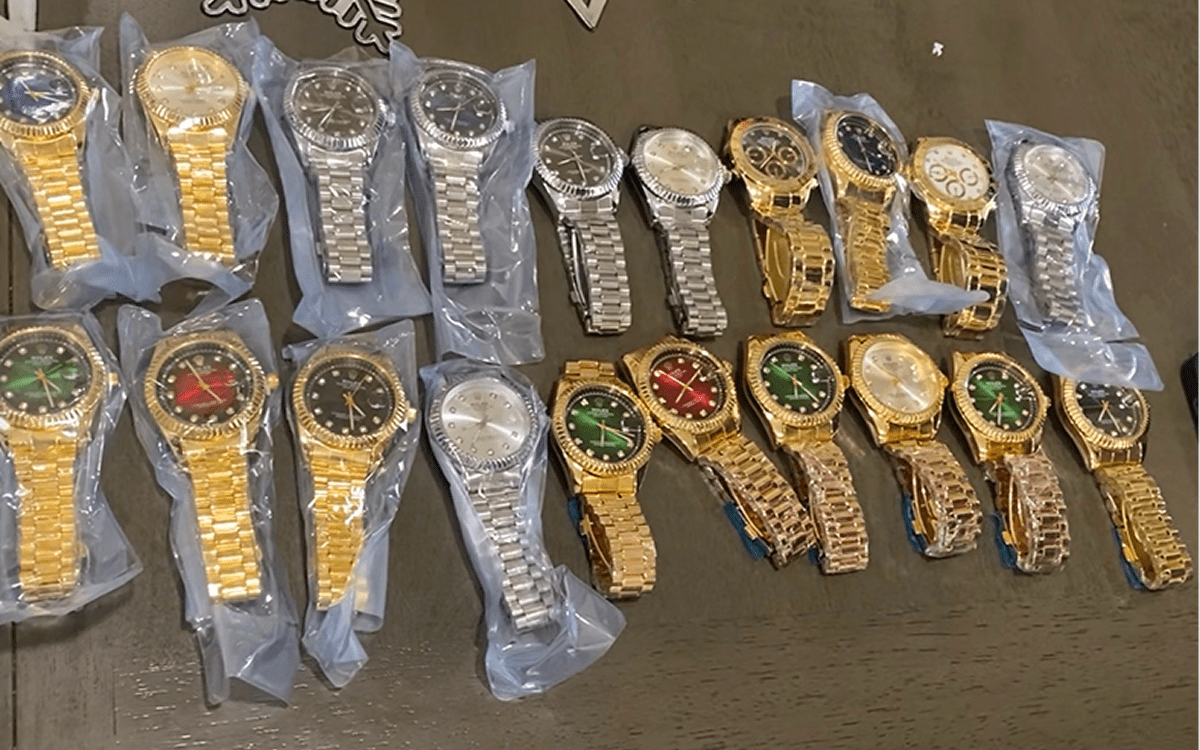 Assorted gold and silver wristwatches on table