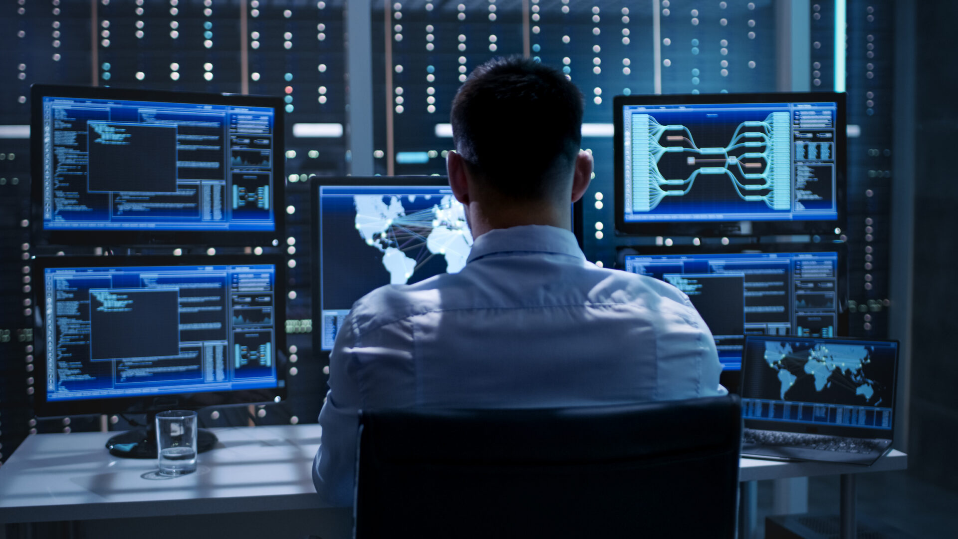 Individual working in a tech control room