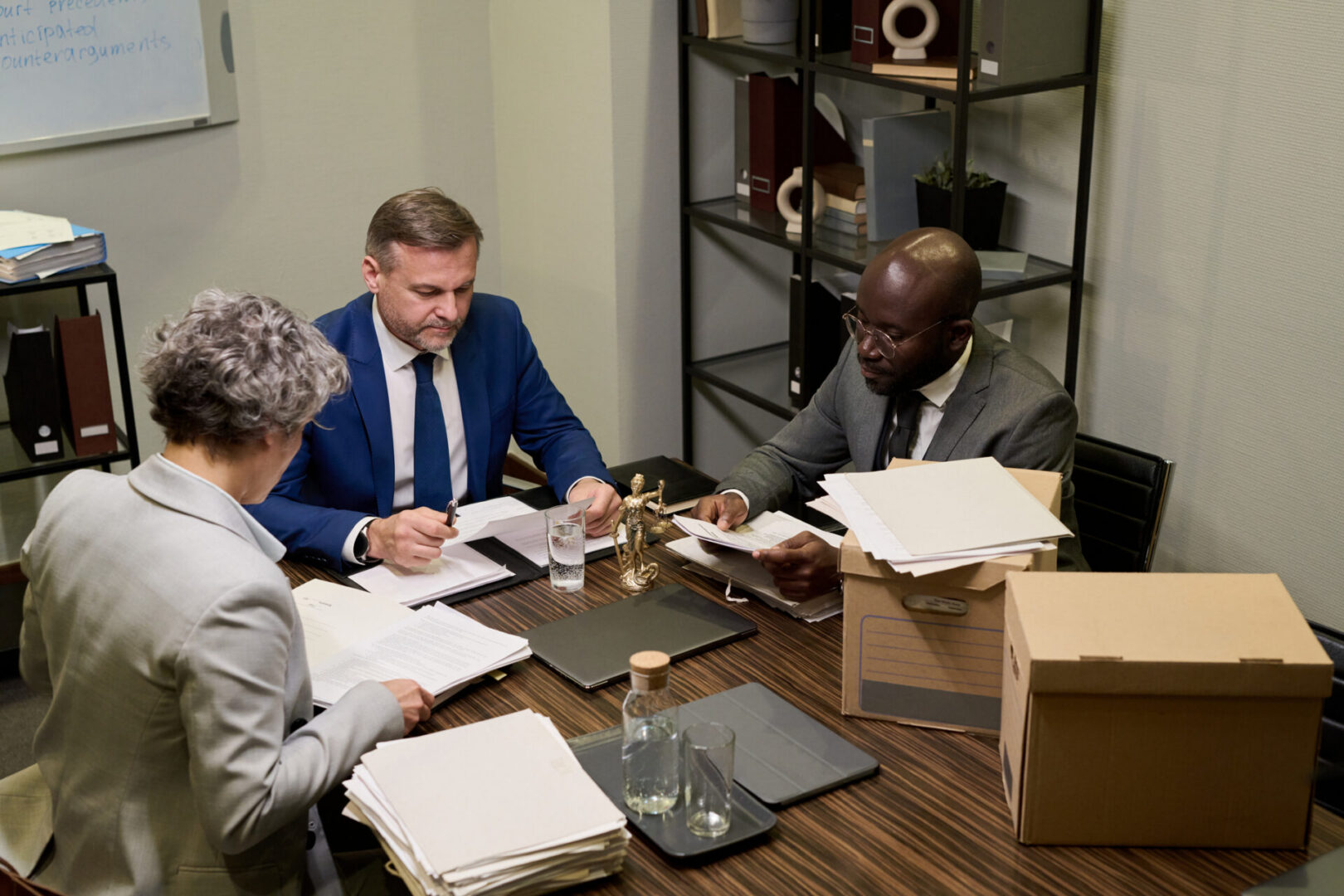 Business meeting with documents and laptops