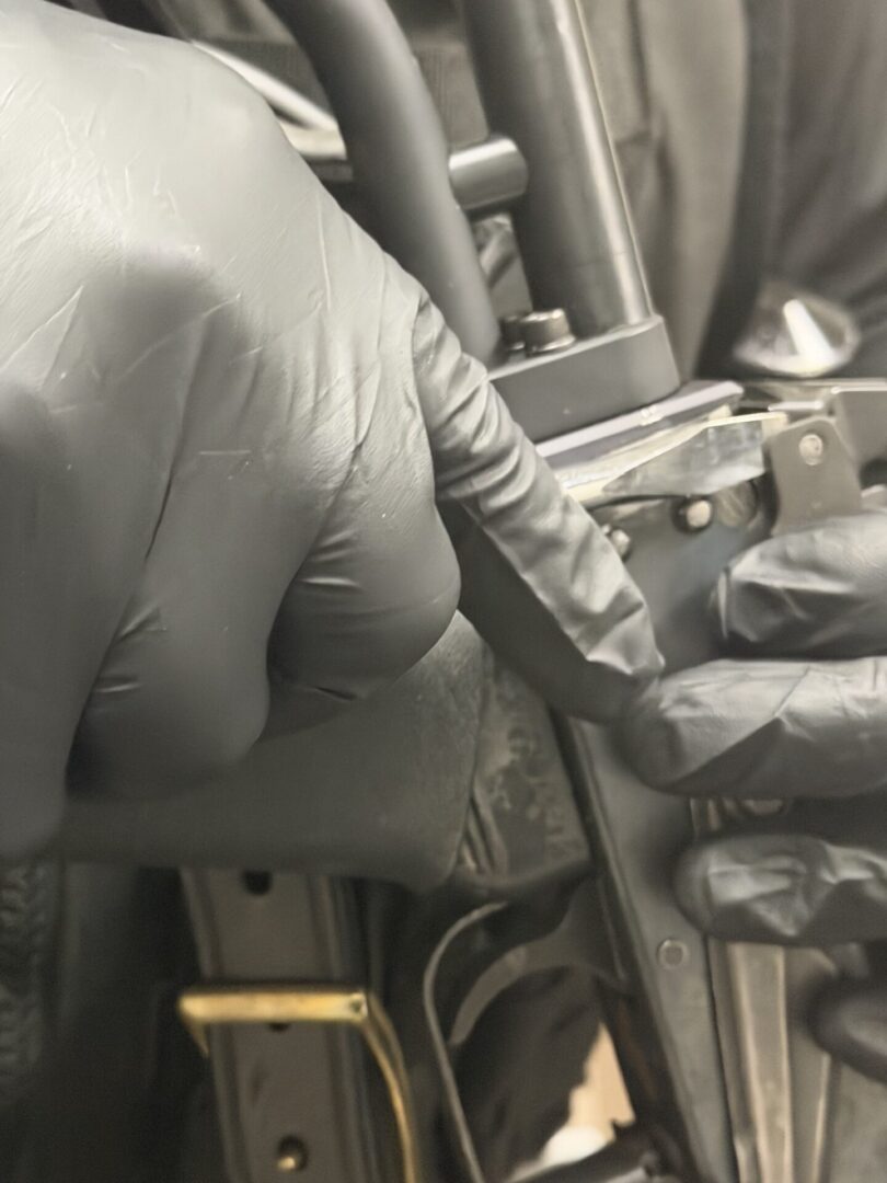 Gloved hands handling firearm components